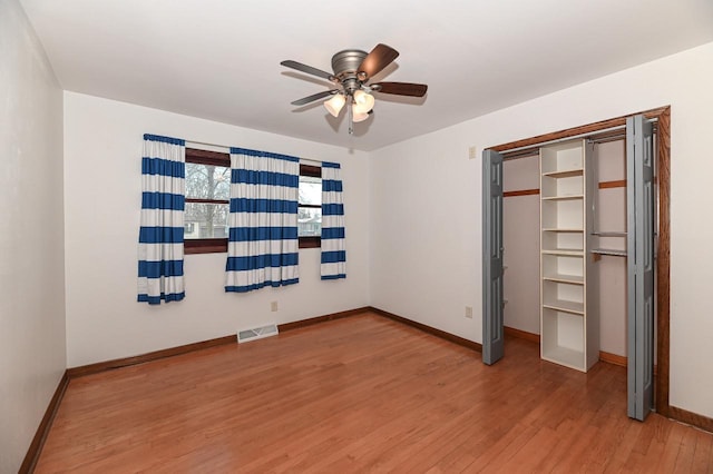 unfurnished bedroom with ceiling fan, a closet, and light hardwood / wood-style flooring