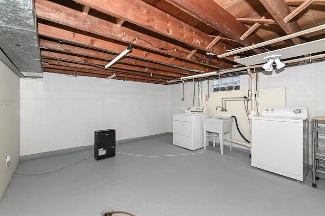 basement with washing machine and dryer and sink