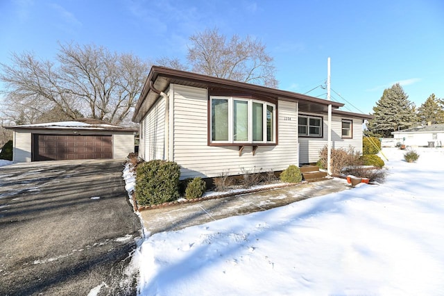 view of front of property featuring a garage and an outdoor structure