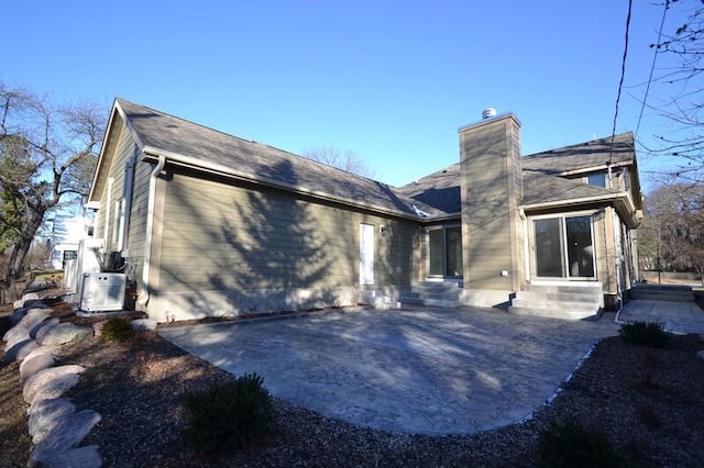 back of house with ac unit and a patio