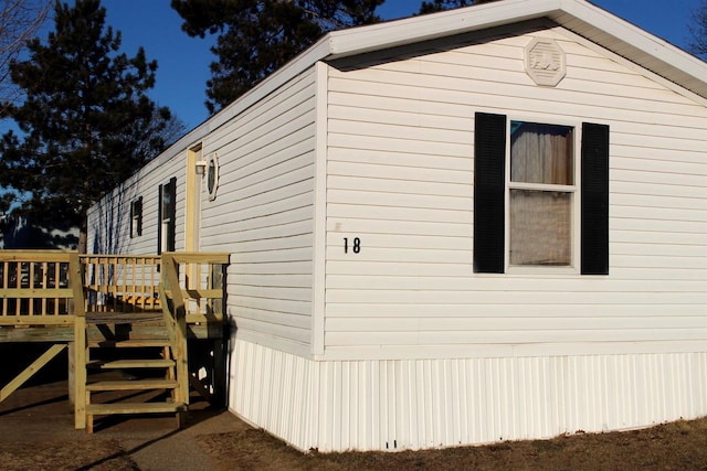 view of side of home with a deck