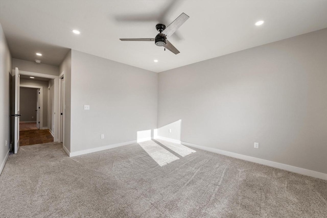 spare room featuring ceiling fan and light carpet