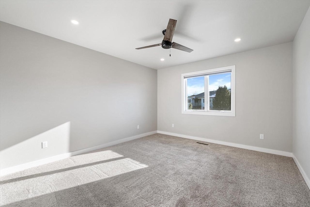 carpeted spare room with ceiling fan