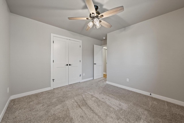 unfurnished bedroom with a closet, carpet floors, and ceiling fan