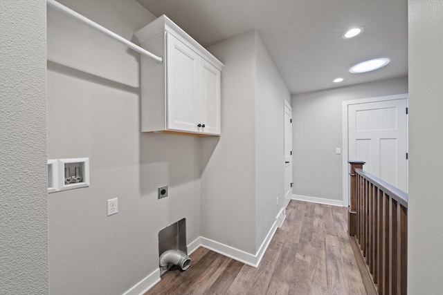 laundry area with electric dryer hookup, hardwood / wood-style floors, hookup for a washing machine, and cabinets