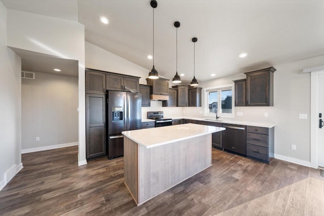 kitchen featuring stainless steel appliances, decorative light fixtures, a center island, dark brown cabinets, and dark wood-type flooring