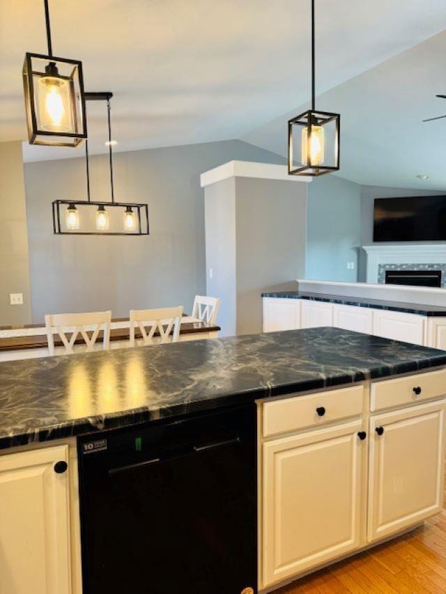 kitchen with light wood-type flooring, decorative light fixtures, white cabinetry, and dishwasher