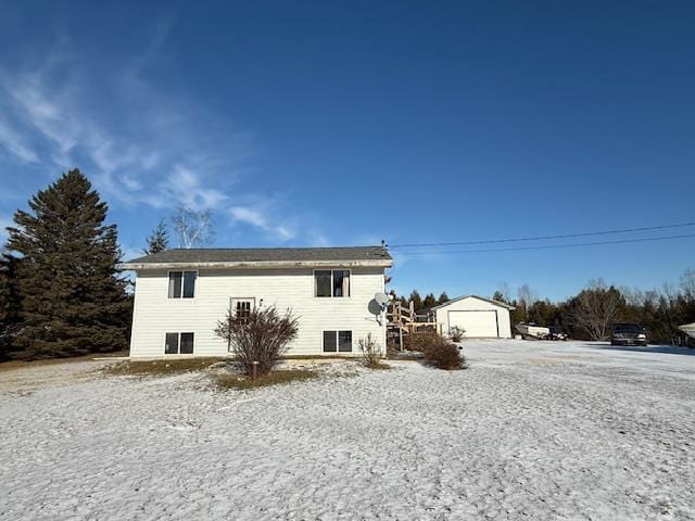 rear view of house with a garage and an outdoor structure