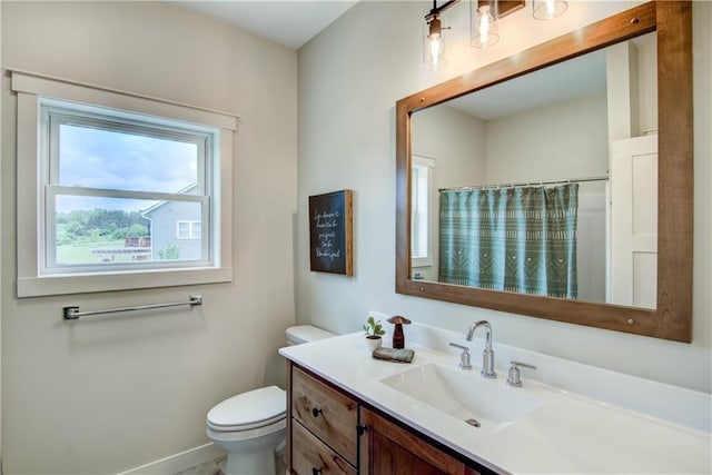 bathroom featuring toilet, a shower with shower curtain, and vanity