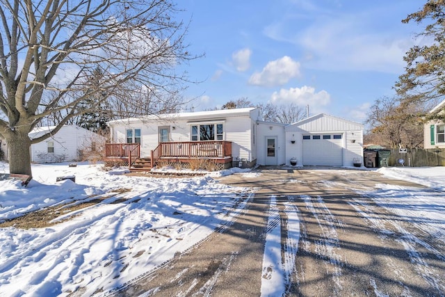 view of front of home featuring a deck and a garage