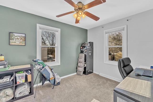 carpeted home office featuring ceiling fan