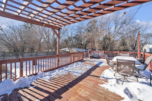 snow covered deck featuring a pergola