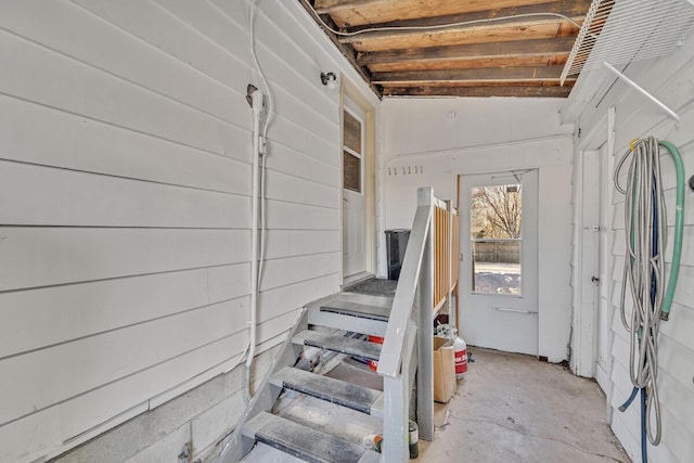 staircase with concrete floors and vaulted ceiling