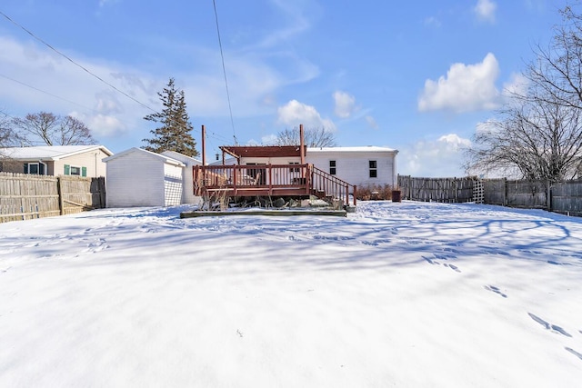 snow covered house with a deck