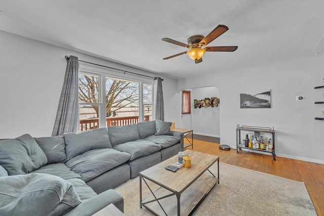 living room featuring ceiling fan and light hardwood / wood-style flooring