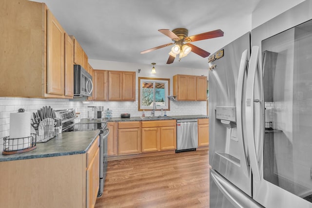 kitchen with sink, stainless steel appliances, light hardwood / wood-style flooring, and light brown cabinets