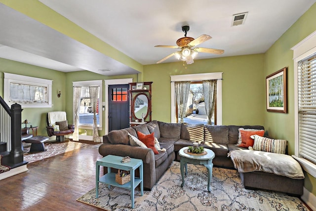 living room with wood-type flooring and ceiling fan