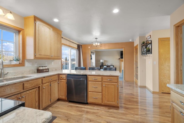 kitchen with light hardwood / wood-style floors, kitchen peninsula, sink, an inviting chandelier, and stainless steel dishwasher