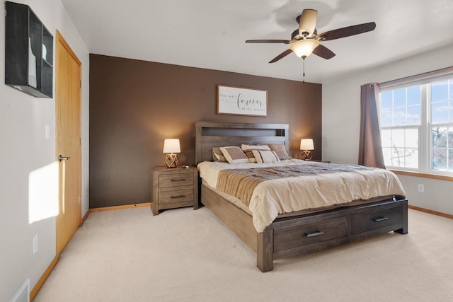 bedroom featuring ceiling fan and light carpet