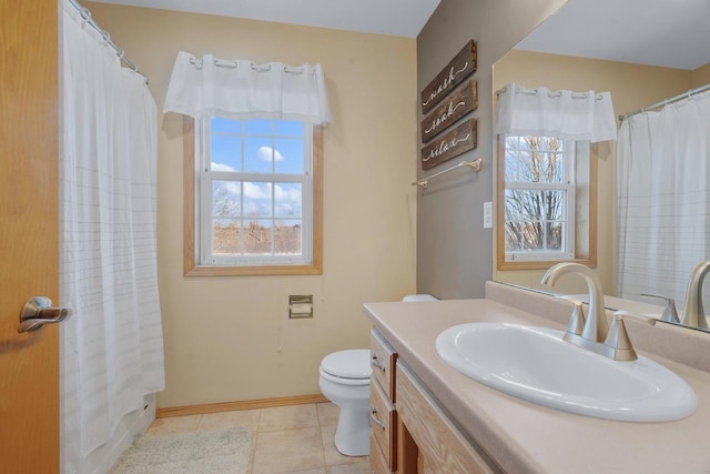 bathroom with toilet, tile patterned flooring, and vanity