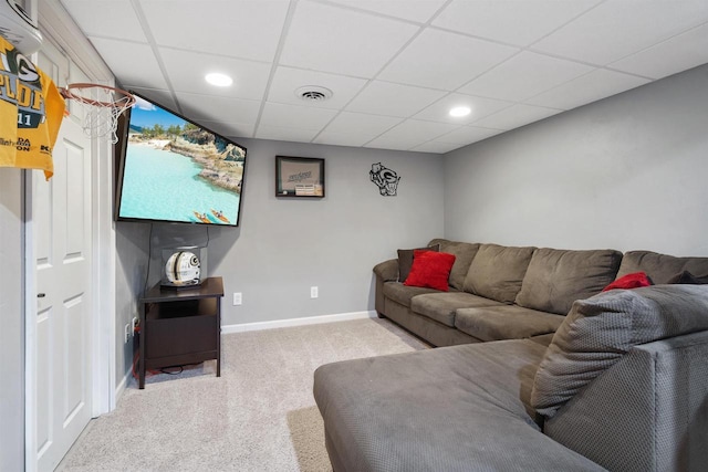 living room featuring a paneled ceiling and light carpet