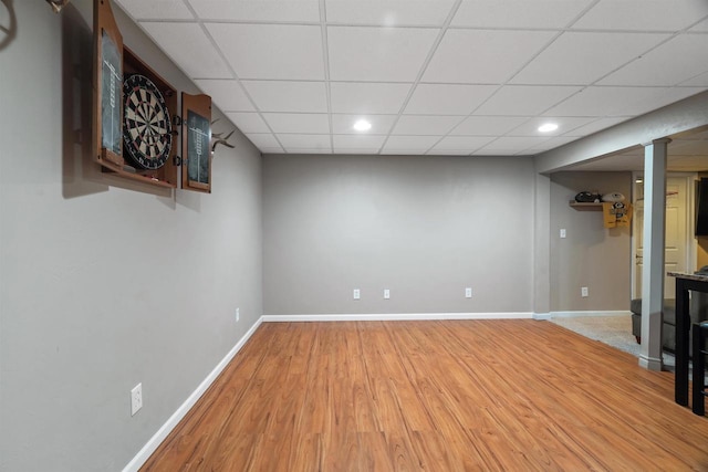 interior space featuring a paneled ceiling and wood-type flooring