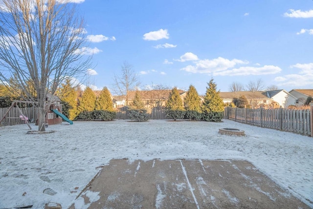 view of yard with a fire pit and a playground