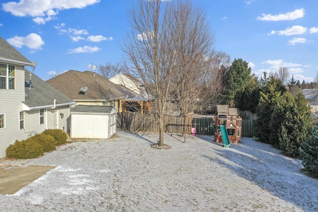 view of yard featuring a playground and a shed