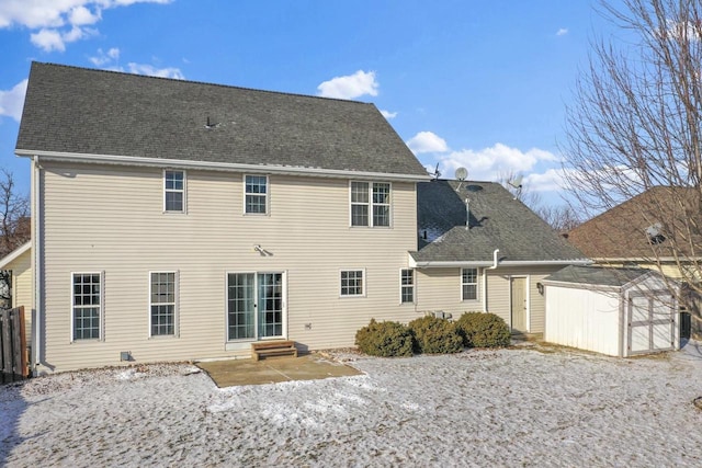 rear view of property with a patio area and a shed