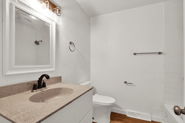 bathroom with hardwood / wood-style floors, vanity, and toilet