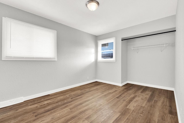 unfurnished bedroom with hardwood / wood-style floors and a closet