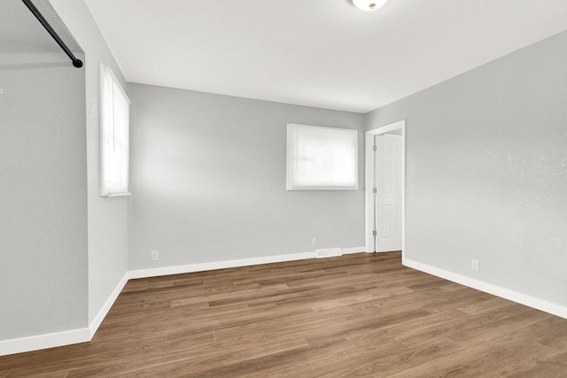 unfurnished room with hardwood / wood-style flooring