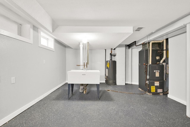 basement featuring sink, heating unit, and gas water heater