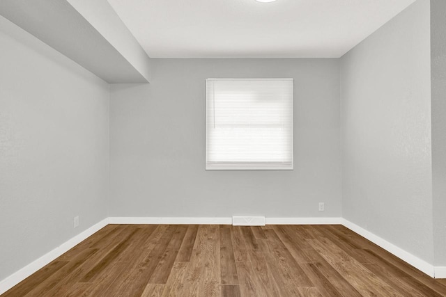 spare room with hardwood / wood-style flooring