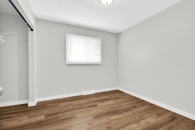 unfurnished bedroom featuring hardwood / wood-style floors and a closet