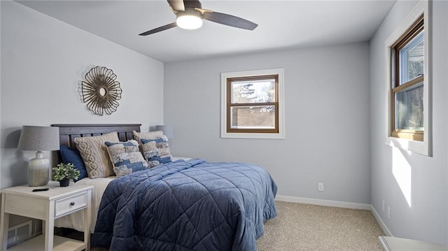 carpeted bedroom with multiple windows and ceiling fan