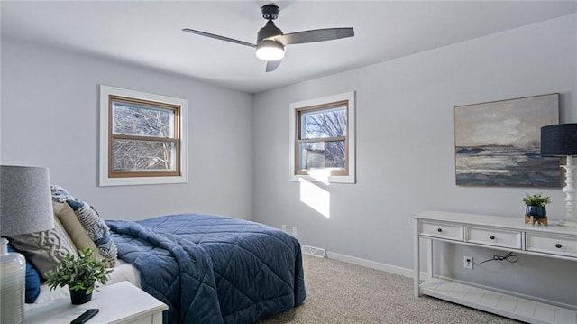 bedroom with ceiling fan and light carpet