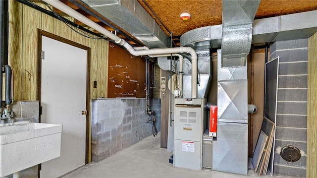 utility room featuring heating unit