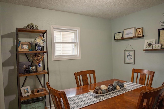 dining space with a textured ceiling