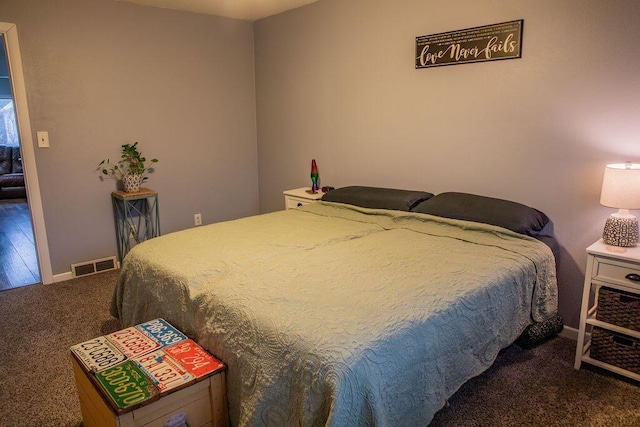 bedroom with dark colored carpet