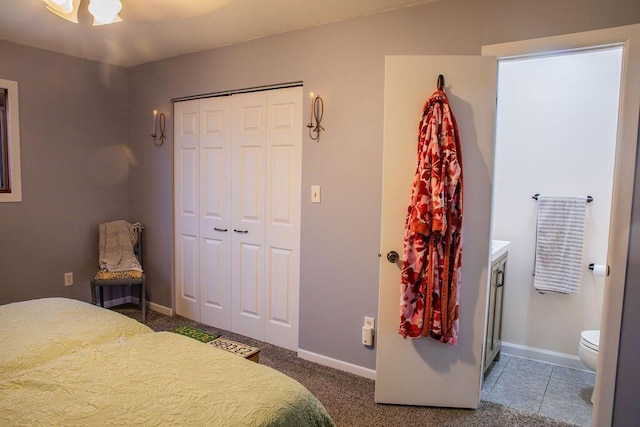 bedroom with ceiling fan, a closet, and ensuite bath