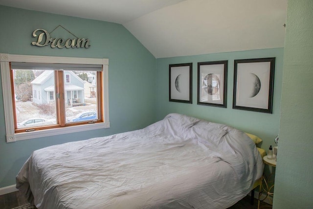 bedroom featuring hardwood / wood-style flooring and vaulted ceiling