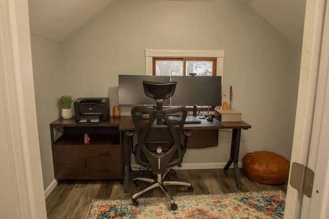 home office featuring lofted ceiling and dark hardwood / wood-style floors