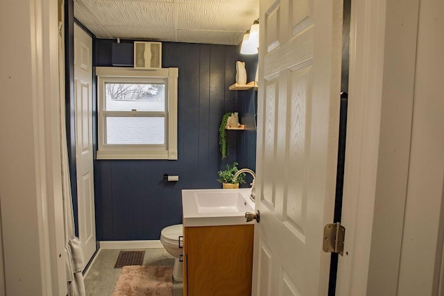 bathroom featuring toilet and vanity