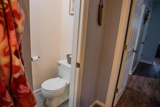 bathroom with toilet and hardwood / wood-style floors