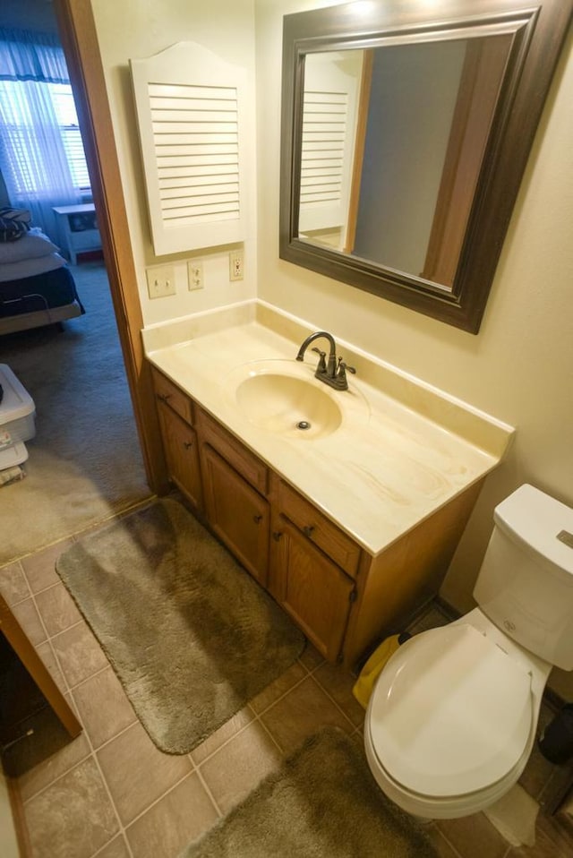 bathroom featuring toilet, vanity, and tile patterned floors