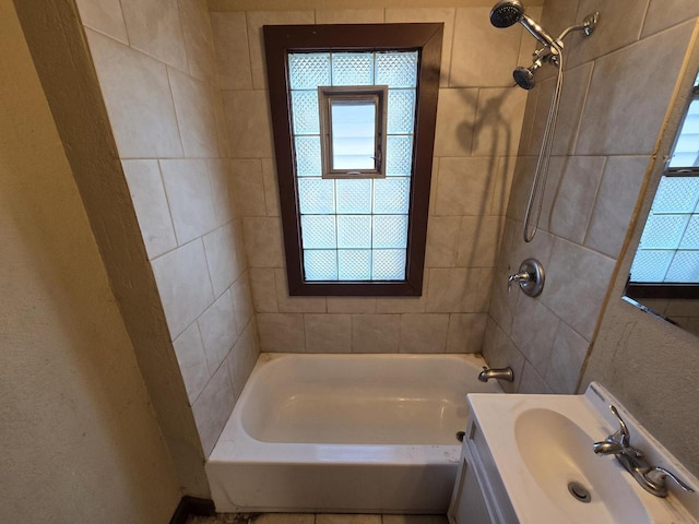 bathroom with vanity and tiled shower / bath combo