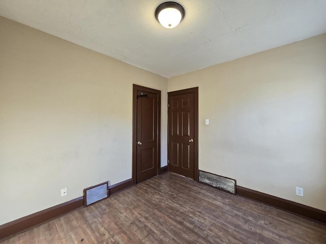 spare room with dark hardwood / wood-style flooring