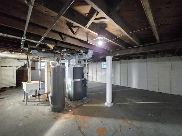 basement with sink, heating unit, and water heater