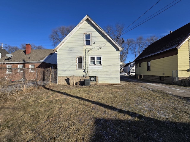 back of property featuring a yard and central AC unit